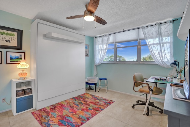 tiled office space with ceiling fan and a textured ceiling