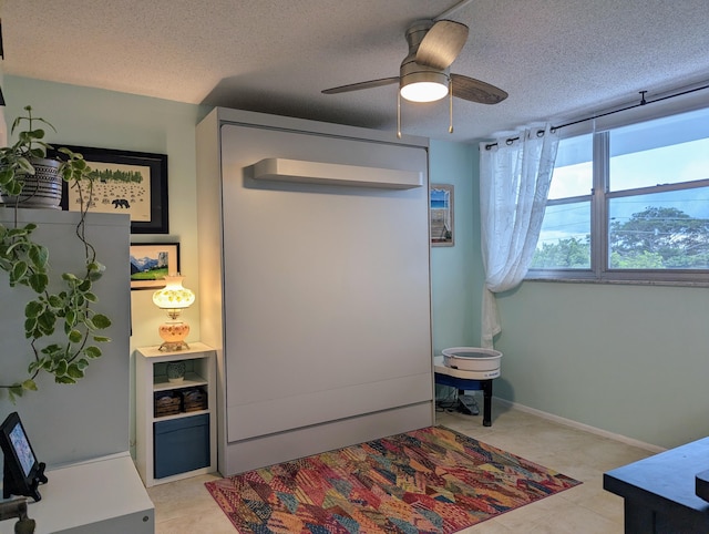 bedroom with a textured ceiling and ceiling fan