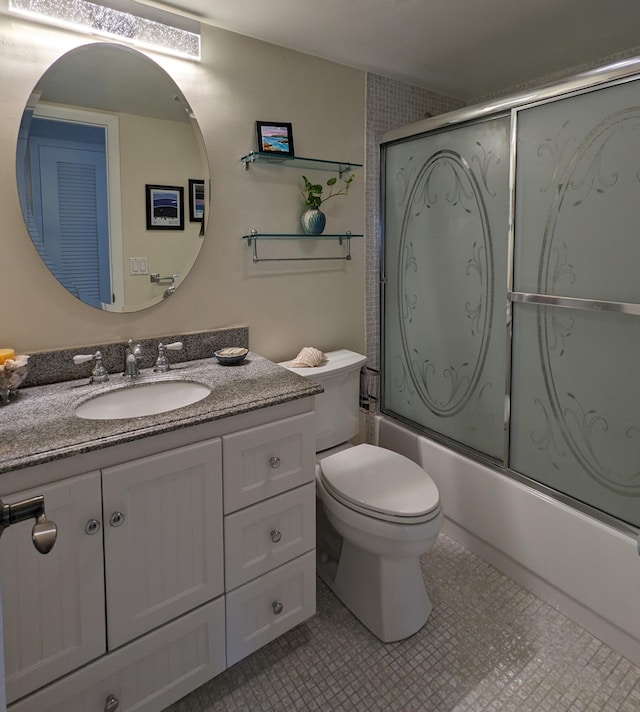 full bathroom featuring toilet, shower / bath combination with glass door, vanity, and tile patterned floors