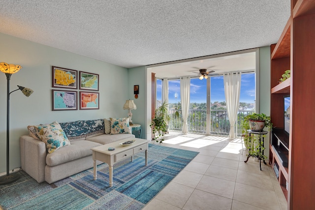 tiled living room with floor to ceiling windows, a textured ceiling, and ceiling fan