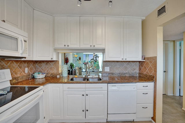 kitchen with white cabinetry, white appliances, sink, and light tile patterned floors