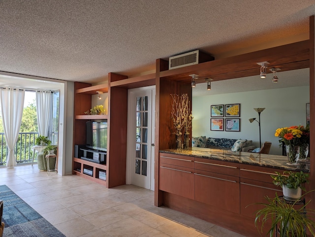 kitchen with a textured ceiling and light tile patterned flooring