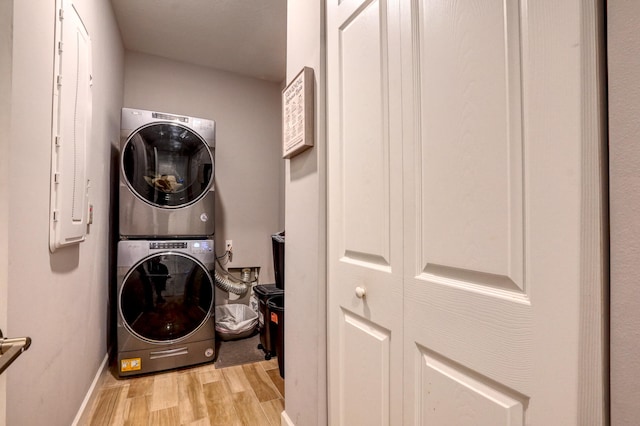 washroom featuring light wood-type flooring and stacked washer and dryer