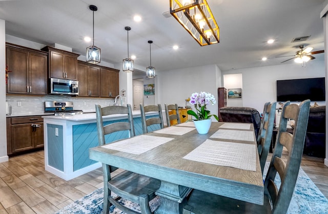 dining area featuring light hardwood / wood-style floors and ceiling fan