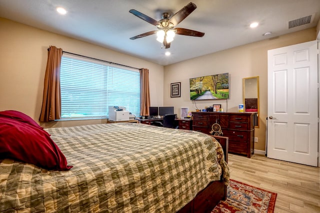 bedroom with ceiling fan and light wood-type flooring