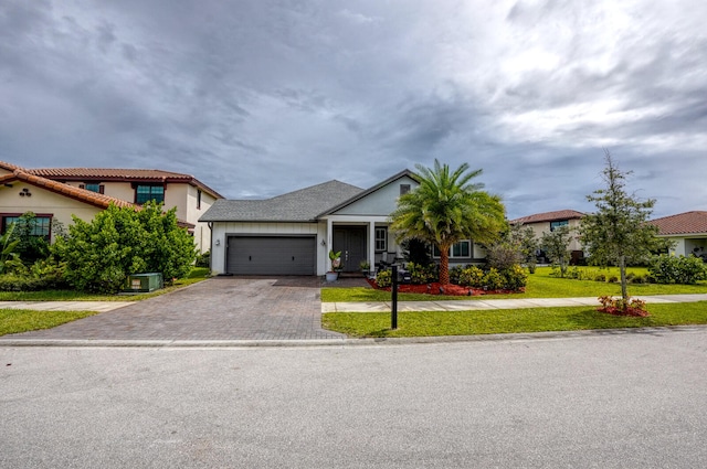 view of front of home featuring a garage and a front lawn