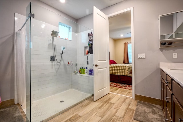 bathroom with vanity and a tile shower