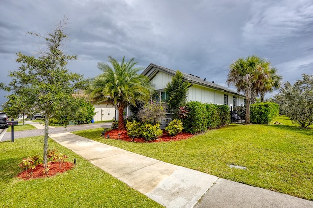 view of side of home with a yard