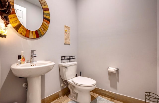 bathroom featuring hardwood / wood-style flooring and toilet