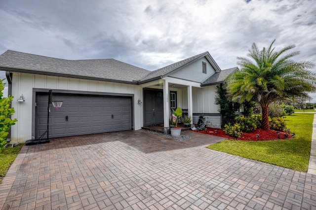 ranch-style home featuring a garage and a front lawn