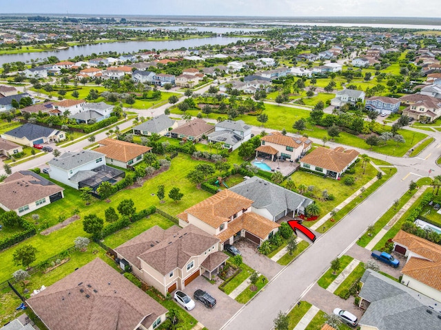 birds eye view of property with a water view