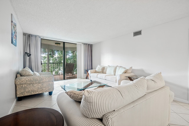 living room featuring a textured ceiling and light tile patterned floors