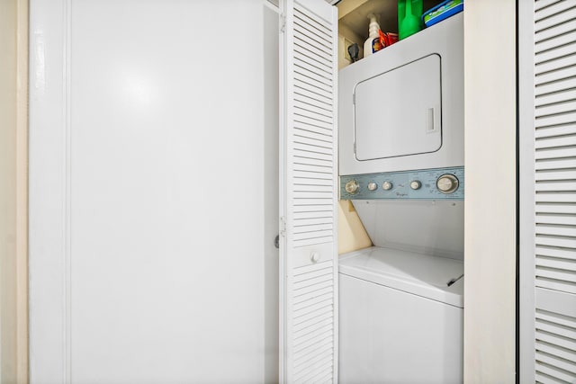 laundry area featuring stacked washer / dryer