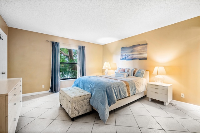 bedroom featuring a textured ceiling and light tile patterned floors