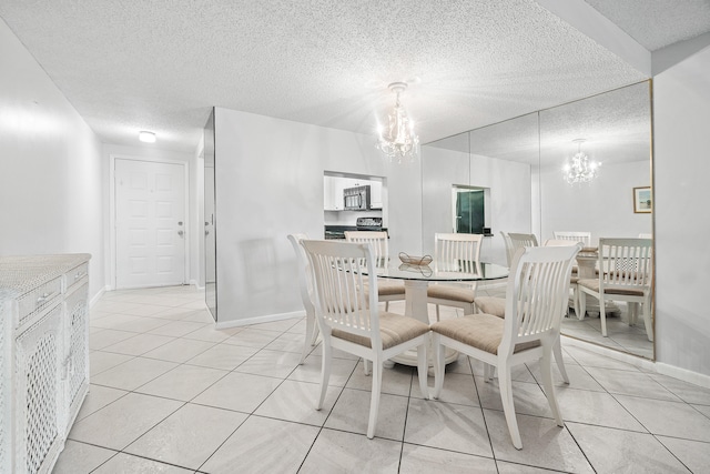 dining room featuring a textured ceiling, an inviting chandelier, and light tile patterned floors