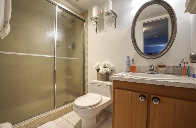 bathroom featuring tile patterned floors, vanity, toilet, and walk in shower