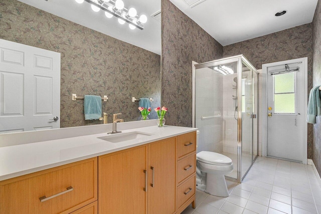 bathroom with vanity, an enclosed shower, toilet, and tile patterned flooring