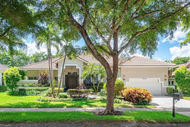 view of front of property with a front lawn and a garage