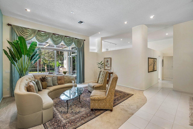 living room with a textured ceiling and light tile patterned floors