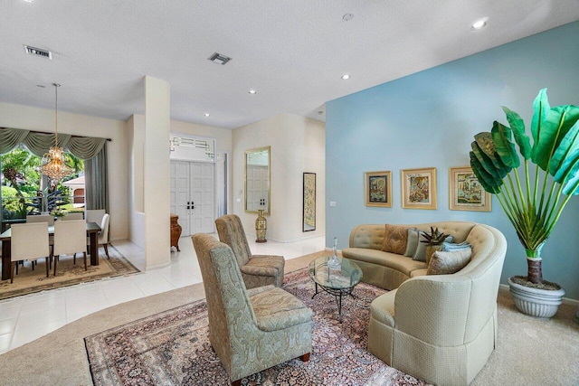 tiled living room with a notable chandelier and a textured ceiling