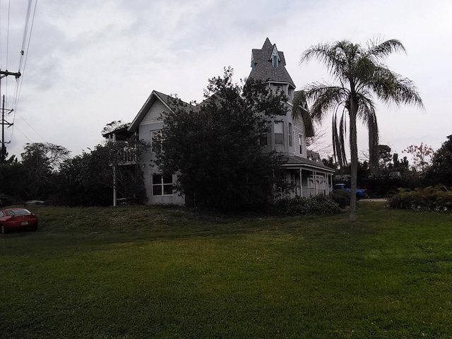 view of side of home with a lawn