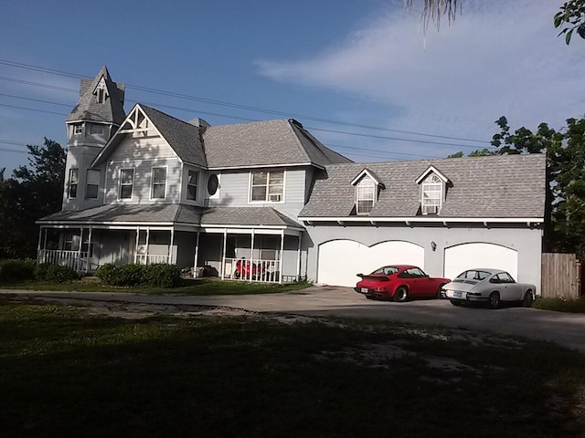 view of front of home with a porch and a garage