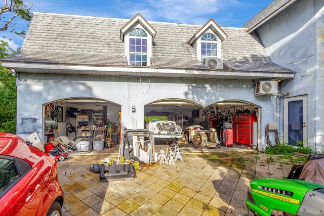 view of patio with ac unit and a garage