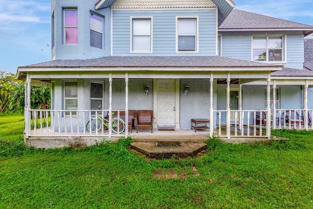 rear view of property with a lawn and covered porch