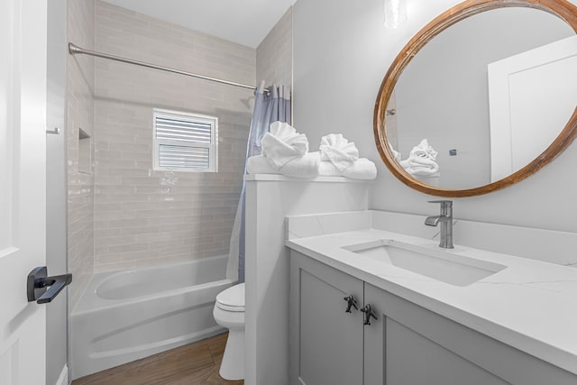 full bathroom featuring hardwood / wood-style floors, vanity, toilet, and shower / bath combo with shower curtain