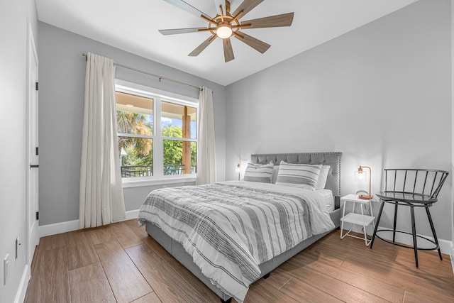 bedroom featuring wood-type flooring, lofted ceiling, and ceiling fan