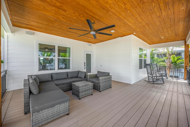 wooden terrace with outdoor lounge area and ceiling fan