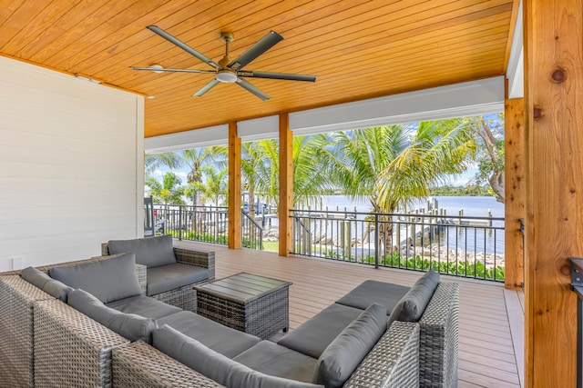 exterior space with ceiling fan, an outdoor hangout area, and a water view