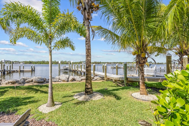 view of yard featuring a boat dock and a water view