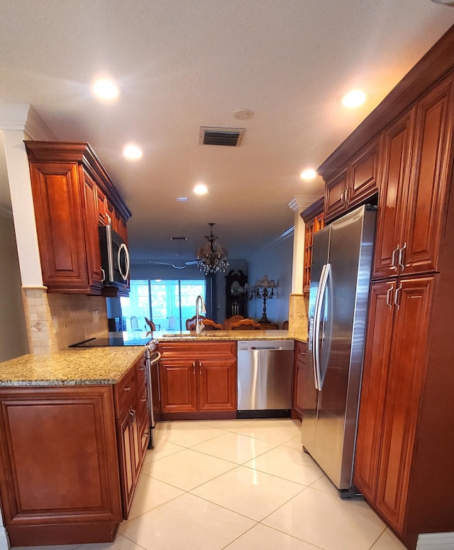 kitchen with ornamental molding, stainless steel appliances, kitchen peninsula, and sink