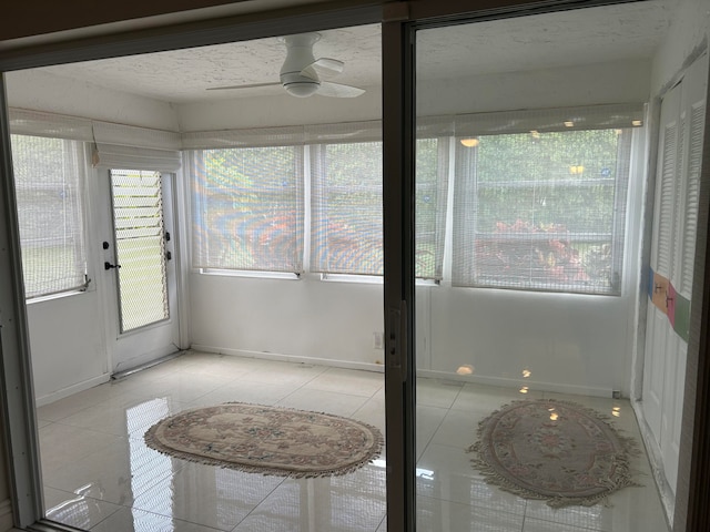 sunroom / solarium featuring ceiling fan