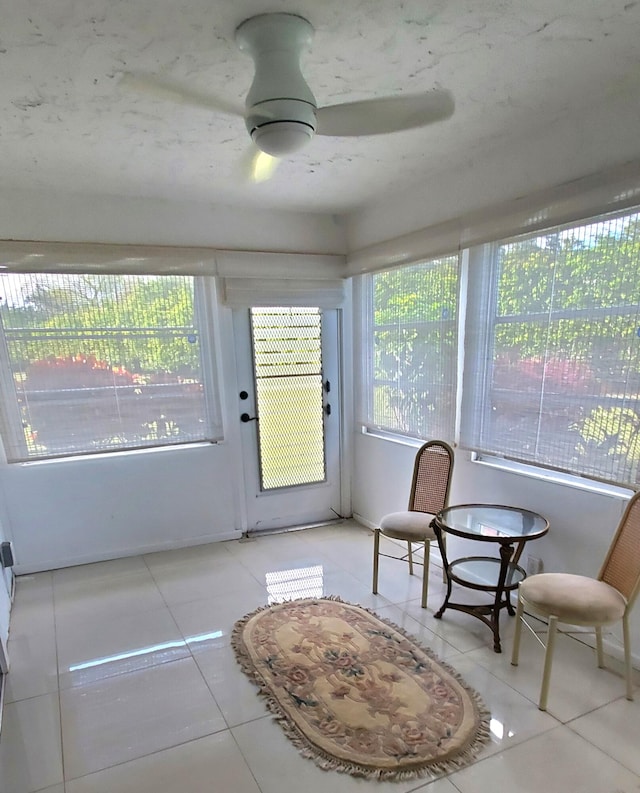 sunroom / solarium featuring ceiling fan