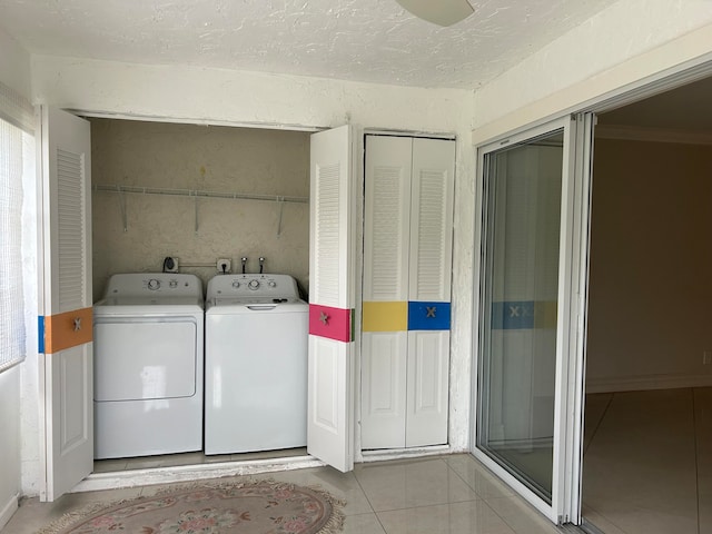 laundry room featuring light tile patterned flooring, separate washer and dryer, and crown molding