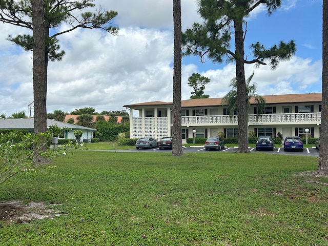 rear view of house featuring a lawn