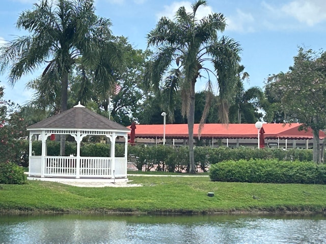 view of home's community with a lawn, a gazebo, and a water view