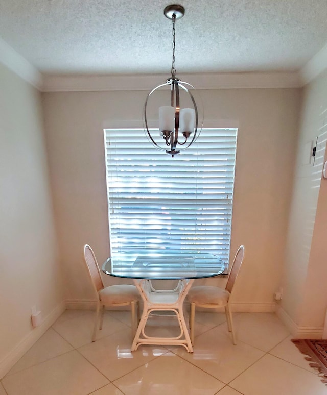 tiled dining space featuring a textured ceiling and a chandelier