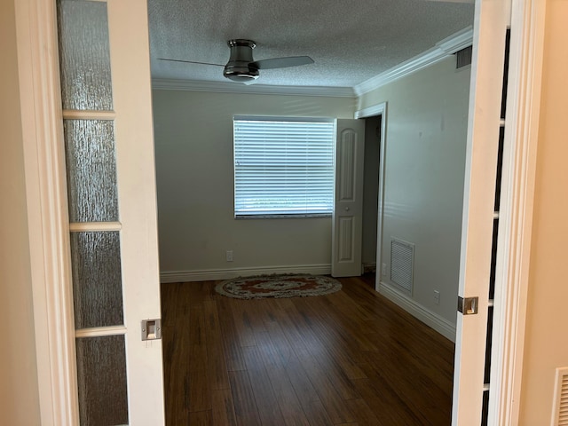 unfurnished room with ceiling fan, hardwood / wood-style flooring, crown molding, and a textured ceiling