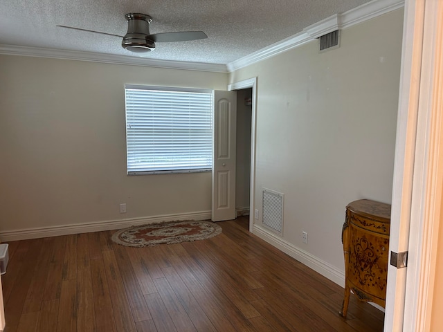 empty room with ceiling fan, hardwood / wood-style flooring, ornamental molding, and a textured ceiling