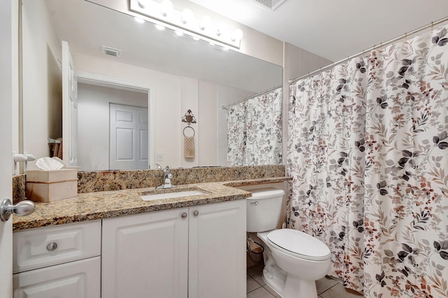 630 S Sapodilla Ave Unit 216, West Palm Beach, FL 33401 - full bathroom featuring toilet, tile patterned flooring, vanity, and a shower with shower curtain