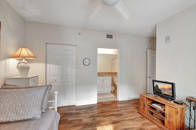 living room featuring light hardwood / wood-style flooring and ceiling fan