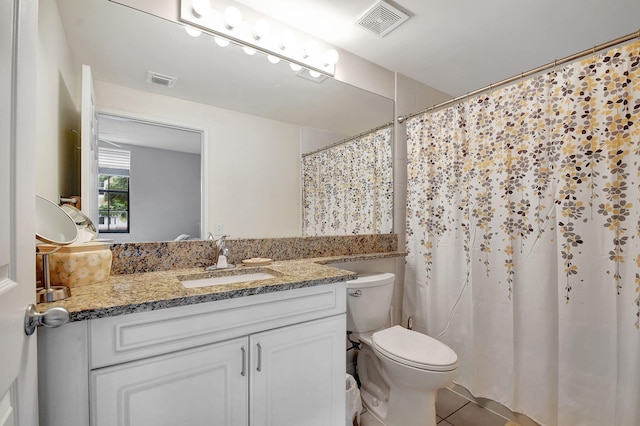 630 S Sapodilla Ave Unit 216, West Palm Beach, FL 33401 - bathroom featuring vanity, toilet, tile patterned flooring, and curtained shower