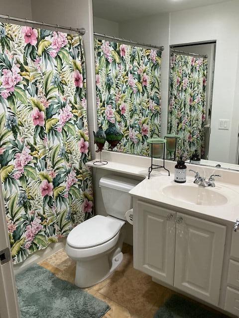 bathroom with tile patterned flooring, vanity, and toilet