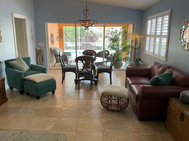 interior space featuring light tile patterned flooring and vaulted ceiling