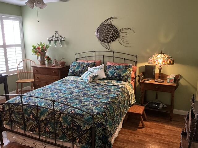 bedroom featuring hardwood / wood-style floors and ceiling fan