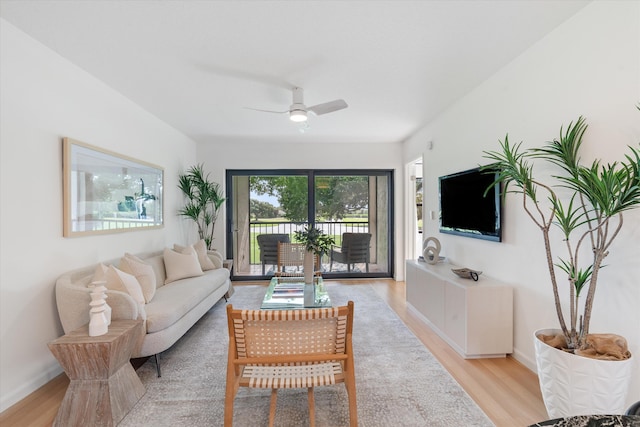 living room with light wood-type flooring and ceiling fan