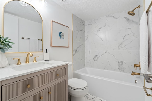 full bathroom with a textured ceiling, vanity, toilet, and tiled shower / bath